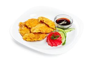 Fried nuggets of chicken breast with sauce photo