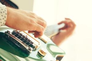 man playing electric guitar photo