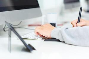 Designer using graphic tablet at office photo