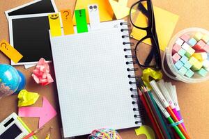Desk of an artist with lots of stationery objects photo