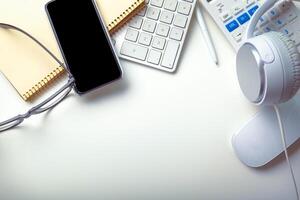 Office desk table with computer keyboard, supplies, calculator, pen, glasses photo