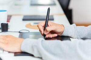 Designer using graphic tablet at office photo