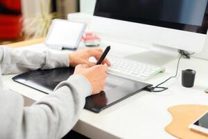 Designer using graphic tablet at office photo