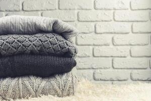 Stack of cozy knitted sweaters photo