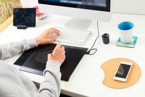 Designer using graphic tablet at office photo