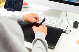 Designer using graphic tablet at office photo