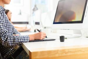 Designer using graphic tablet at office photo