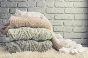 Stack of cozy knitted sweaters photo