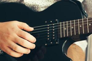 man playing electric guitar photo