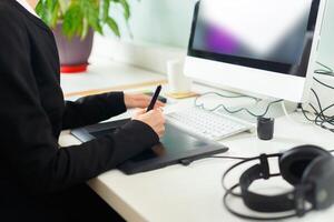 Designer using graphic tablet at office photo