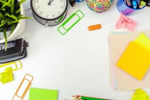 Work place of a creative person with a variety of colorful stationery objects photo