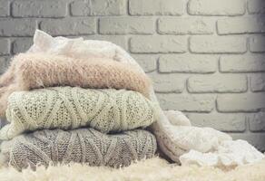 Stack of cozy knitted sweaters photo