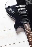 Electric guitar on old wooden surface photo