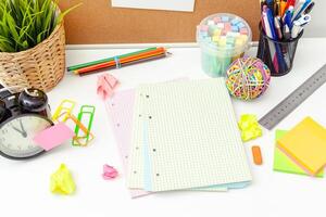 Work place of a creative person with a variety of colorful stationery objects photo