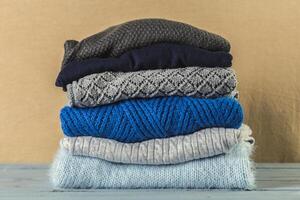 Stack of cozy knitted sweaters photo