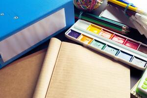 Desk of an artist with lots of stationery objects photo