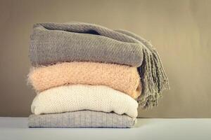 Stack of cozy knitted sweaters photo