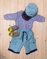 baby clothes for boys on wooden background photo