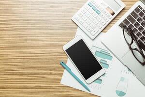 Office table with smartphone on it. View from above photo