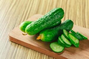 cucumbers on wooden background photo