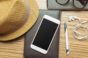 Office table with smartphone on it. View from above photo