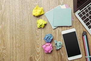 Office table with smartphone on it. View from above photo