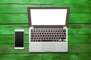 Office table with smartphone on it. View from above photo