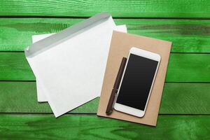 Office table with smartphone on it. View from above photo