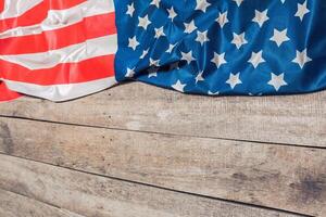 An American Flag Lying on an aged, weathered rustic wooden background photo