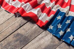 An American Flag Lying on an aged, weathered rustic wooden background photo