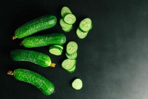 Fresh cucumber on black background photo