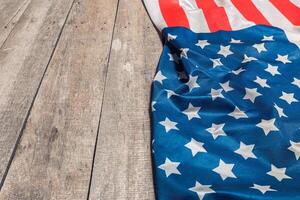 An American Flag Lying on an aged, weathered rustic wooden background photo