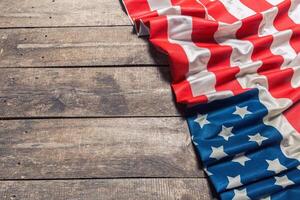 An American Flag Lying on an aged, weathered rustic wooden background photo