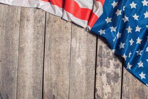 An American Flag Lying on an aged, weathered rustic wooden background photo