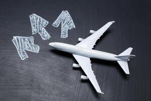 toy airplane over chalkboard background and arrows drawings photo