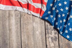 An American Flag Lying on an aged, weathered rustic wooden background photo