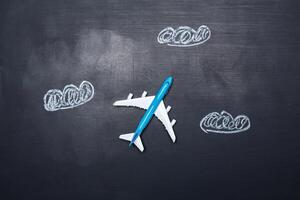 toy airplane over chalkboard background and arrows drawings photo
