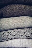 Stack of cozy knitted sweaters photo