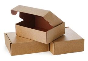 Stacked brown cardboard boxes in various sizes arranged on a white background photo