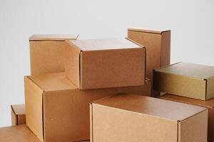 Stacked brown cardboard boxes in various sizes arranged on a white background photo