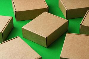 Brown cardboard boxes arranged on a vibrant green surface photo