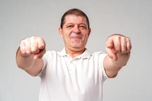 An older man smiling and reaching out with both hands photo