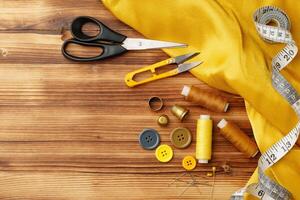 Crafting tools and materials arranged on a wooden table for sewing projects photo