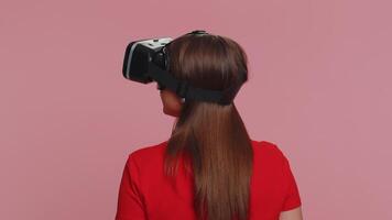 Young woman using virtual reality headset helmet to play simulation game app, watching content video