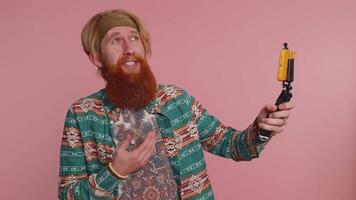 Man blogger influencer taking selfie on smartphone, communicating call online with subscribers video