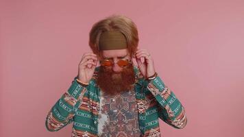 Hippie redhead man listening music and dancing disco fooling around having fun relaxing on party video