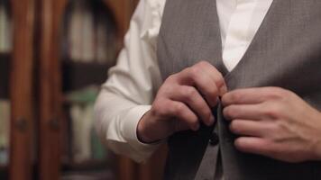 Buttoning jacket with hands close up, man in suit fastens buttons on his jacket preparing to go out video