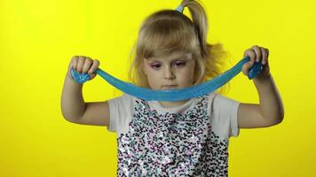 Kid playing with hand made toy slime. Child having fun making turquoise slime. Preschool girl video