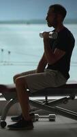 An Individual Engaging in Dumbbell Exercises in a Beautiful Scenic Gym Environment video