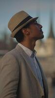 A Stylish and Elegant Profile of a Man Donning a Hat Set Against a Beautiful, Scenic Background video